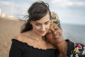 Female couple being close on beach