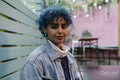 Portrait of young woman with blue hair