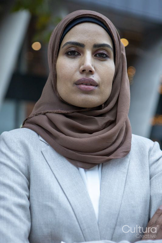 Portrait of businesswoman in hijab standing in city