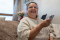 Senior woman using smart phone in living room