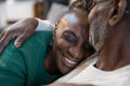 Smiling senior couple hugging on sofa