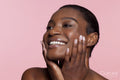 Smiling young woman touching face