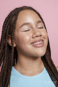 Studio portrait of girl with braids and decorative stickers on face