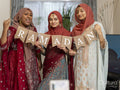 Women holding Ramadan pennant at home