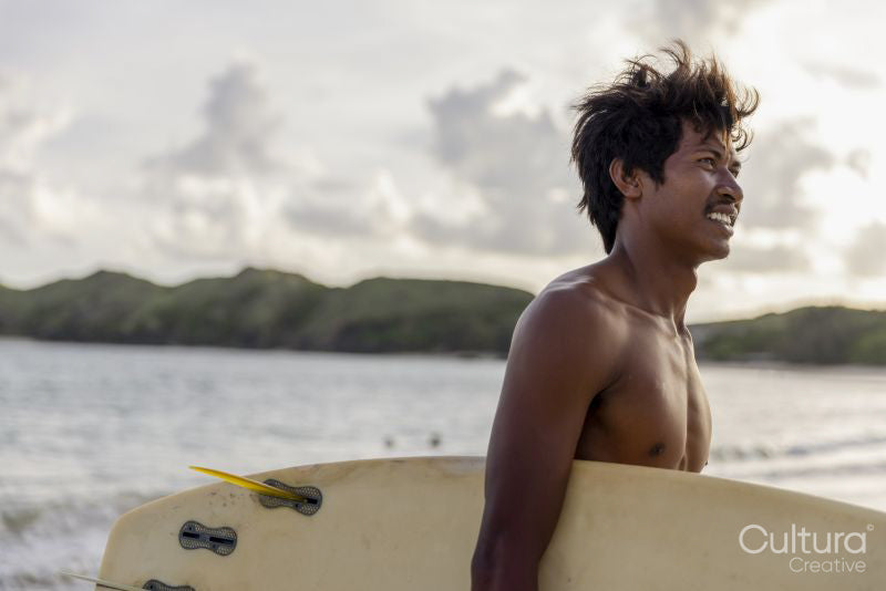 Indonesia, Lombok, Side view of male surfer looking at view