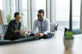 Business people having meeting in office lobby