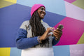 Beautiful woman using phone on colorful background