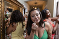 Group of women applying makeup before going to party