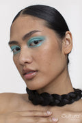 Portrait of woman with black braid around neck