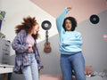 Mother and daughter dancing in room