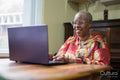 Mature woman using laptop at home