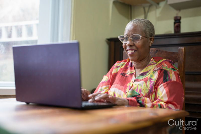 Mature woman using laptop at home