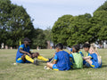 Coach giving instructions to kids on soccer field
