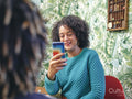 Woman taking picture of man with smart phone