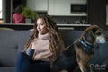 Young woman and dog relaxing in living room
