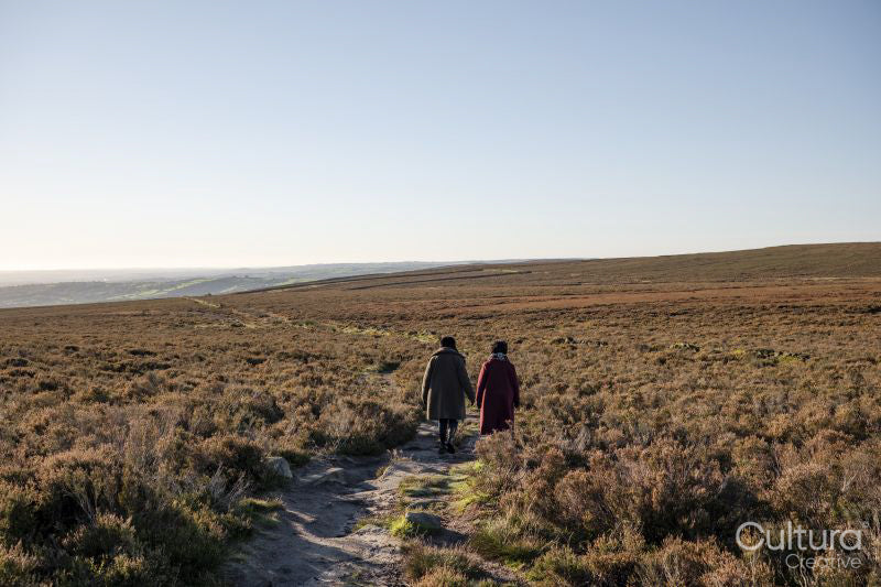 Rear view of two women hiking in moorland