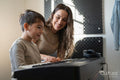 Mother and son playing music keyboard at home