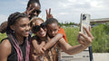 Smiling family taking selfie outdoors