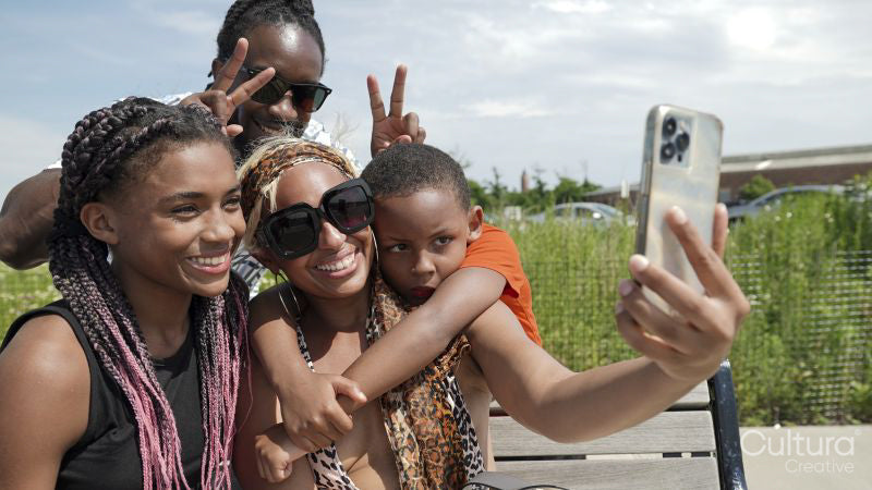 Smiling family taking selfie outdoors