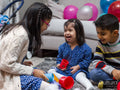 Smiling siblings playing at home