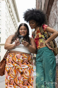 Two women using phone in street