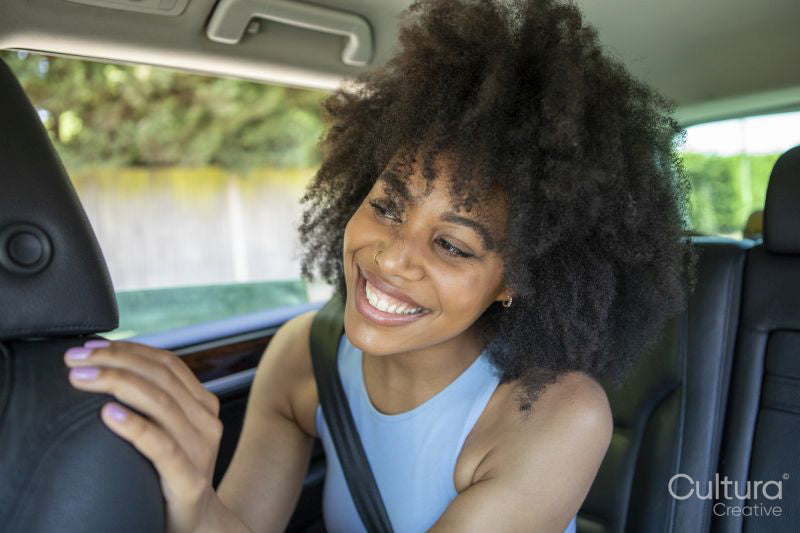 Young woman sitting in car