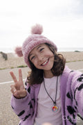 Portrait of smiling girl making peace gesture while taking selfie