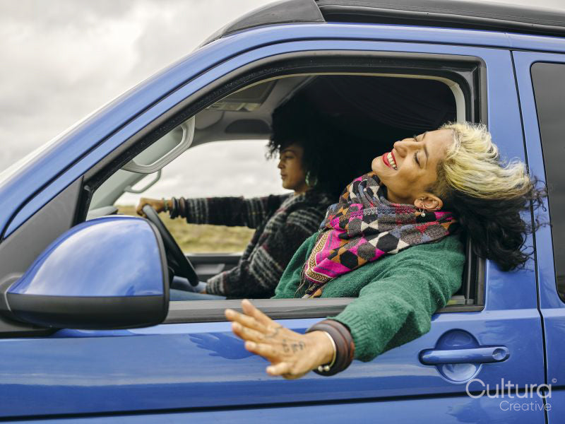 Smiling woman leaning out of car window