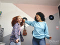 Mother and daughter dancing in room