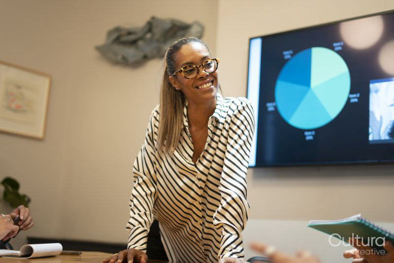 Businesswoman showing graphs during presentation
