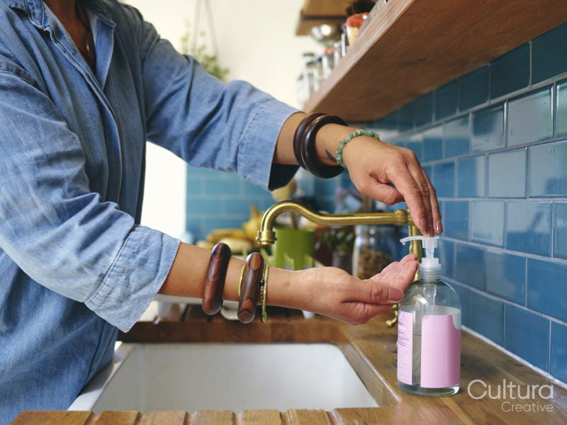 Woman washing hands in kitchen,close-up