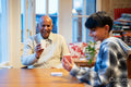 Senior man and grandson playing cards together
