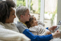 Smiling couple with daughter looking at baby ultrasound image