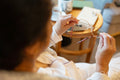 Rear view of senior lady holding eyeglasses while sitting in chair at nursing home