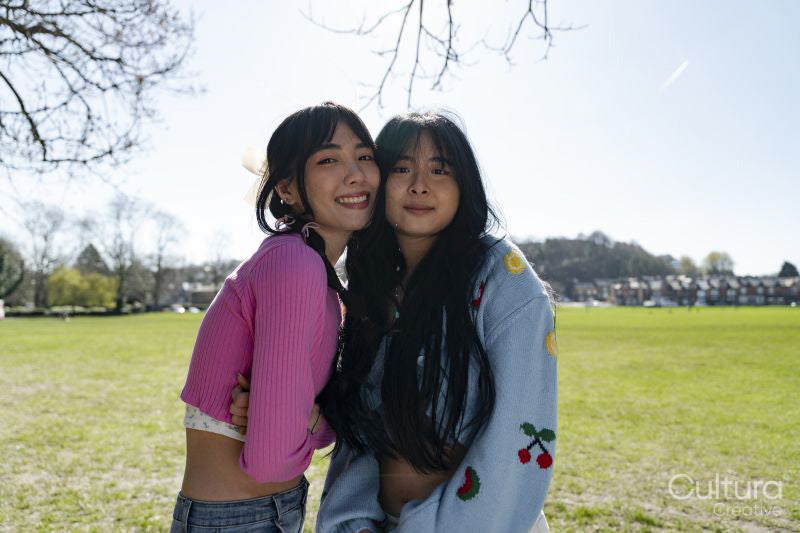 Portrait of young female friends in park
