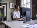 Teenage girl using computer in office