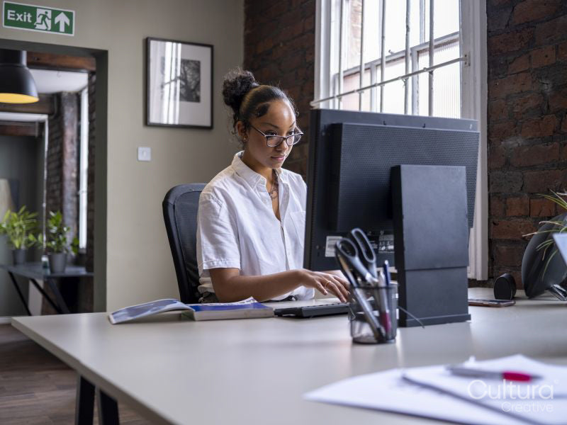 Teenage girl using computer in office
