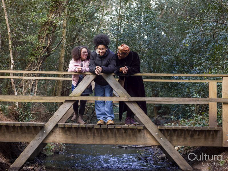 Mother with two daughters on footbridge