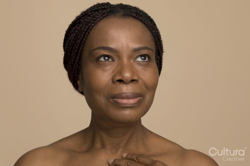 Studio portrait of mature woman with braided hair