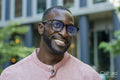 Outdoor portrait of smiling man wearing glasses