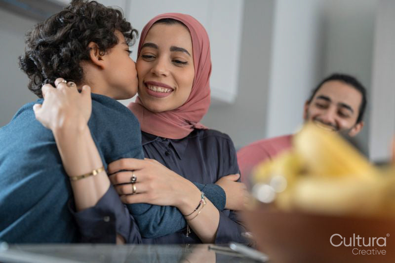 Boy kissing mother on cheek