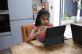 Girl using digital tablet at home