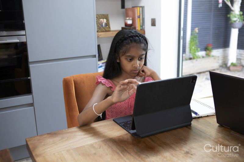 Girl using digital tablet at home