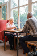 Senior people playing chess in nursing home