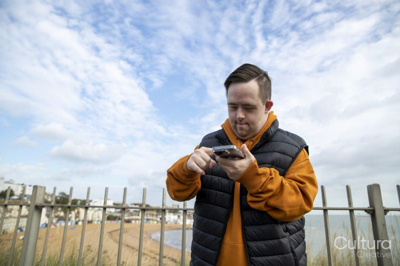 Man using smart phone by beach