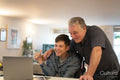 Father using laptop with son