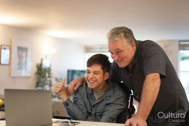 Father using laptop with son