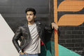 Young man leaning against wall