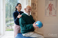 Smiling senior man exercising with physical therapist
