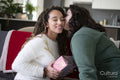 Woman giving Christmas gift to partner